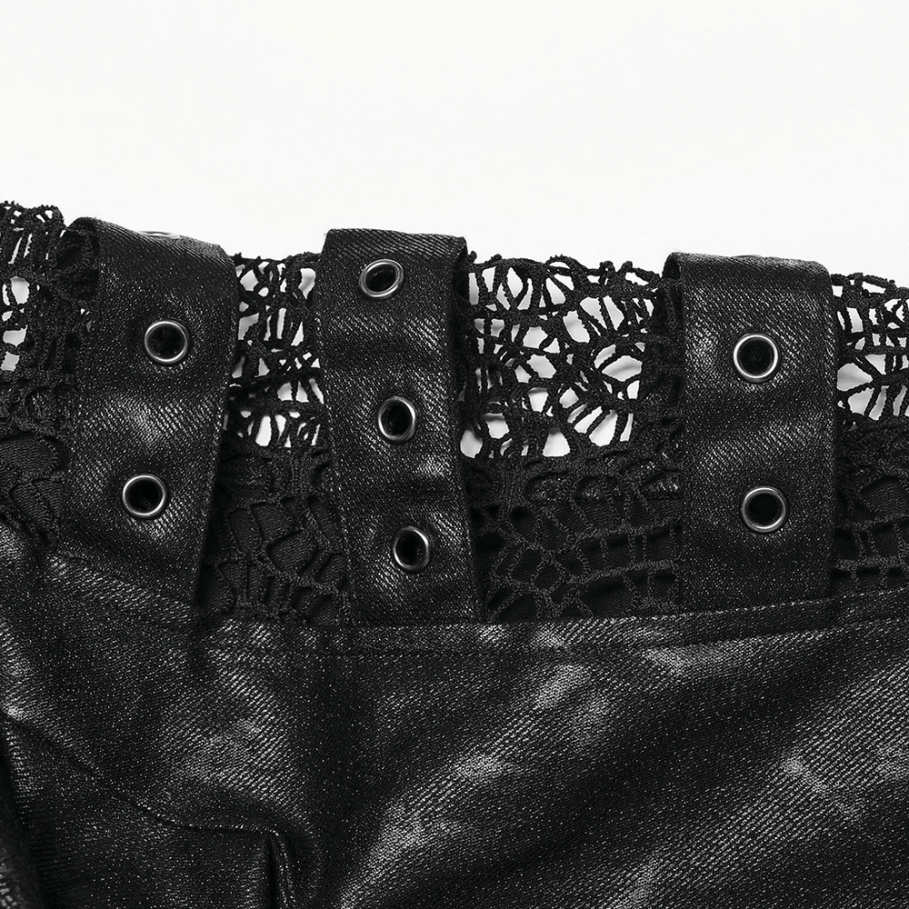 Close-up of gothic coat's intricate black lace and metal snap details, showcasing edgy fashion elements.