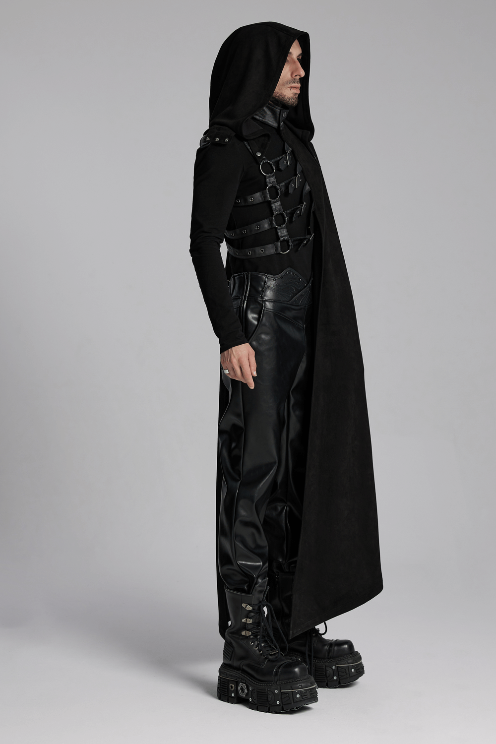 Gothic hooded half cape with leather straps, showcasing a punk style on a model dressed in edgy black attire.