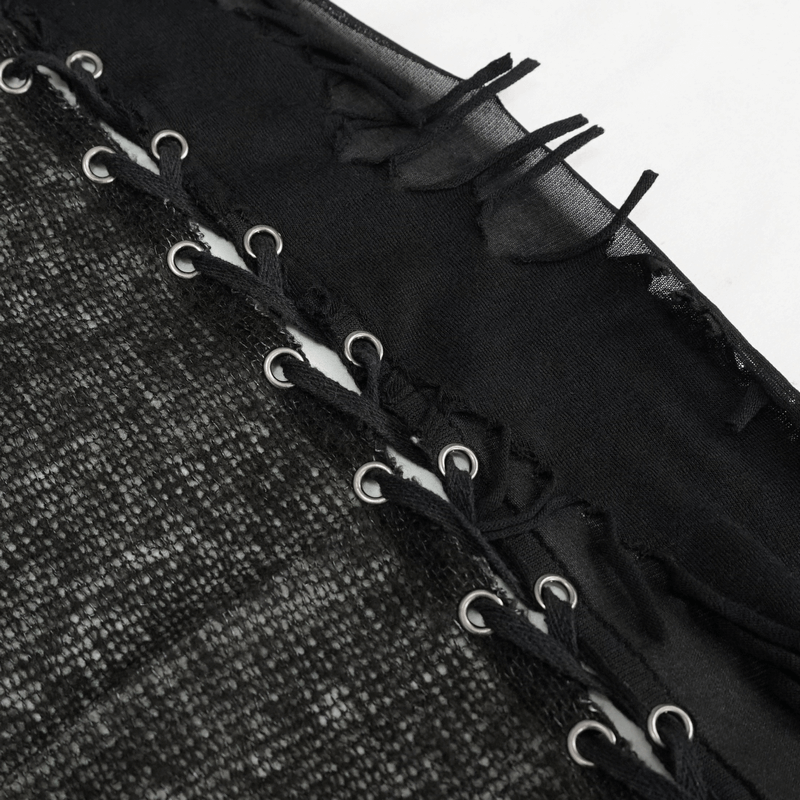 Close-up of gothic lace detailing on black asymmetric vest with lacing at the back, showcasing intricate craftsmanship.