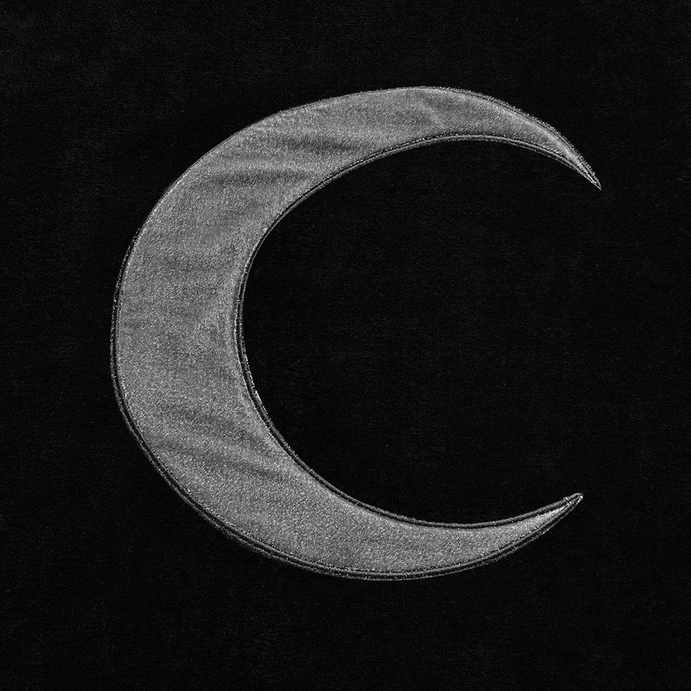 Elegant silver crescent moon embroidery on a dark velvet background, perfect for a gothic hooded cape.