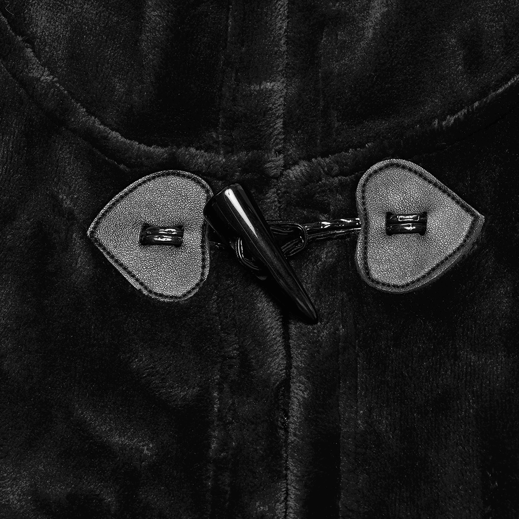 Close-up of gothic hooded velvet cape fastened with black heart-shaped buttons and a pointed toggle.