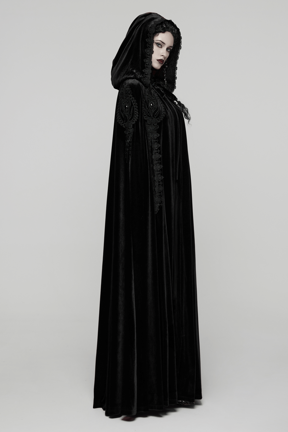 Gothic Hooded Velvet Cloak with Lace and Gem Details displayed on model, showcasing luxurious velvet and dramatic hood.
