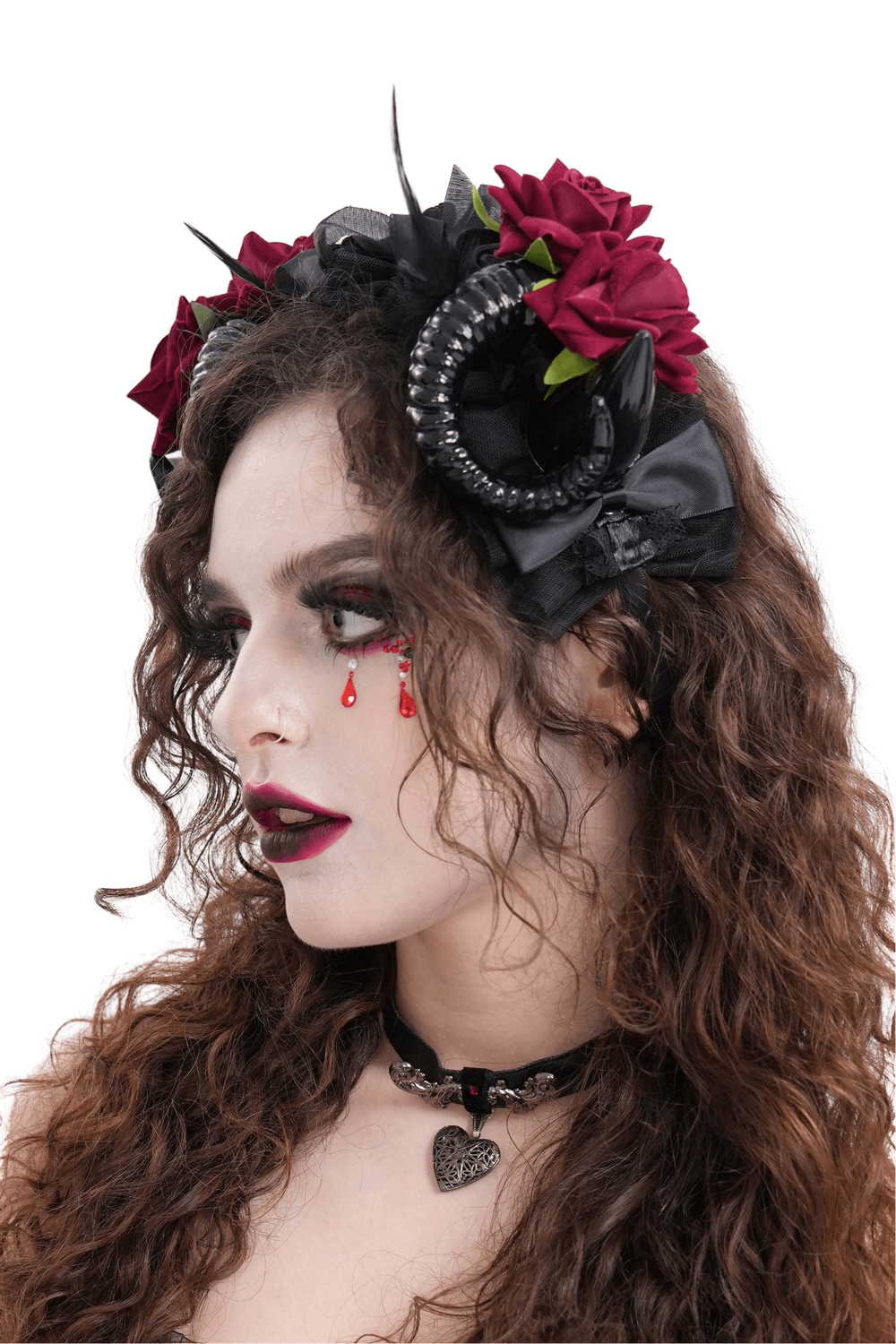 Gothic horned headpiece adorned with red roses and black ribbons, perfect for alternative fashion and events.