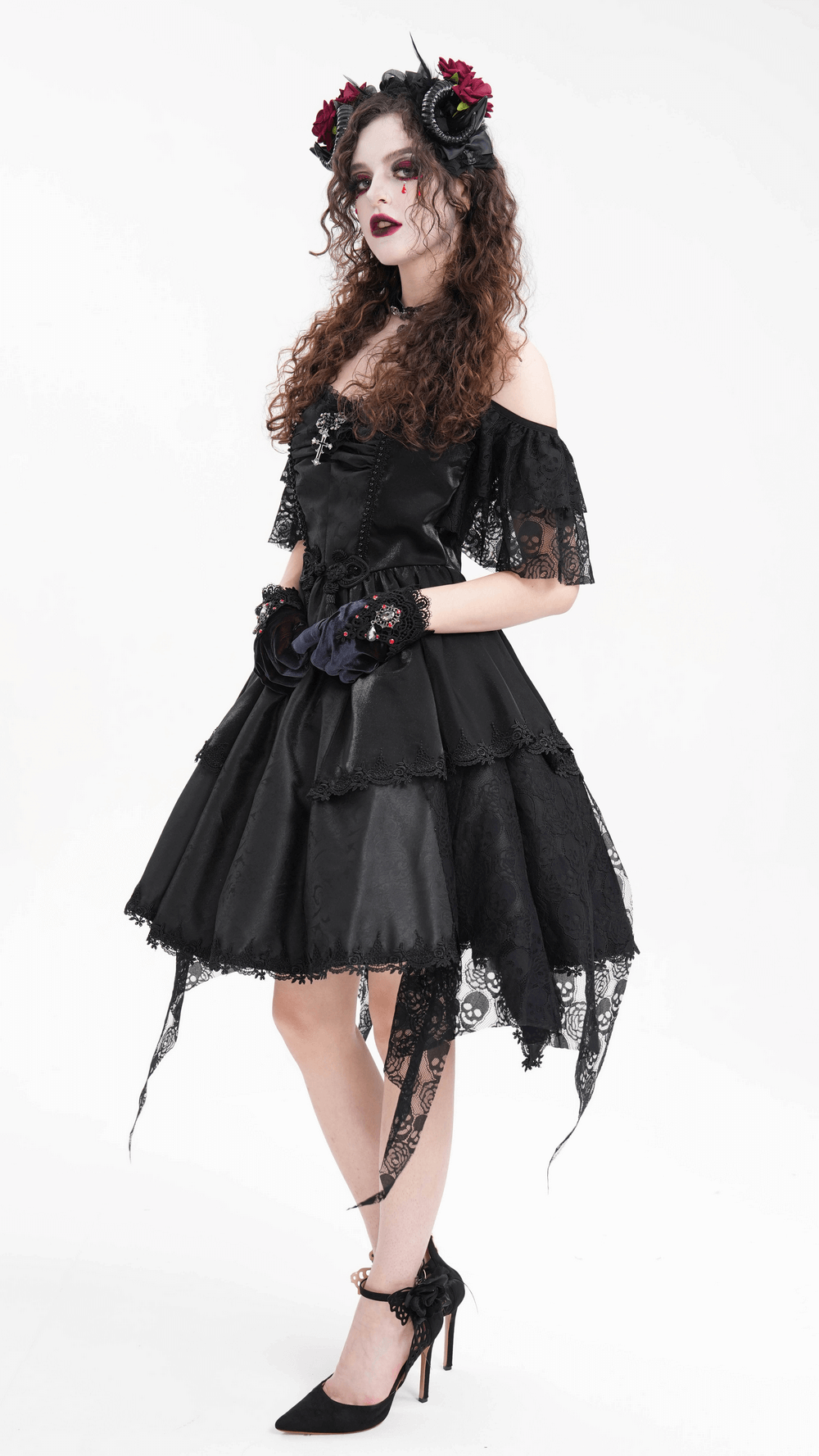 Elegant woman in gothic black dress with lace accents, wearing a floral horned headpiece and black gloves.