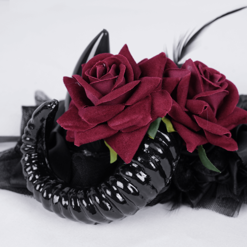 Gothic horned headpiece adorned with deep red roses and black ribbon ties for a dramatic alternative fashion look.