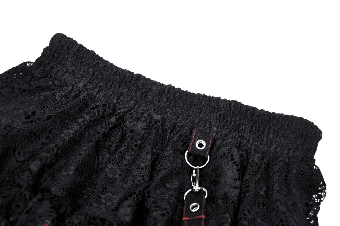 Close-up of black lace skirt waistband featuring chain detail for a punk rock, gothic fashion look.