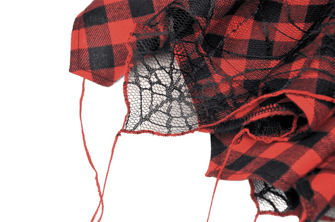 Close-up of gothic skirt fabric featuring red plaid and intricate black lace details, showcasing edgy punk rock style.