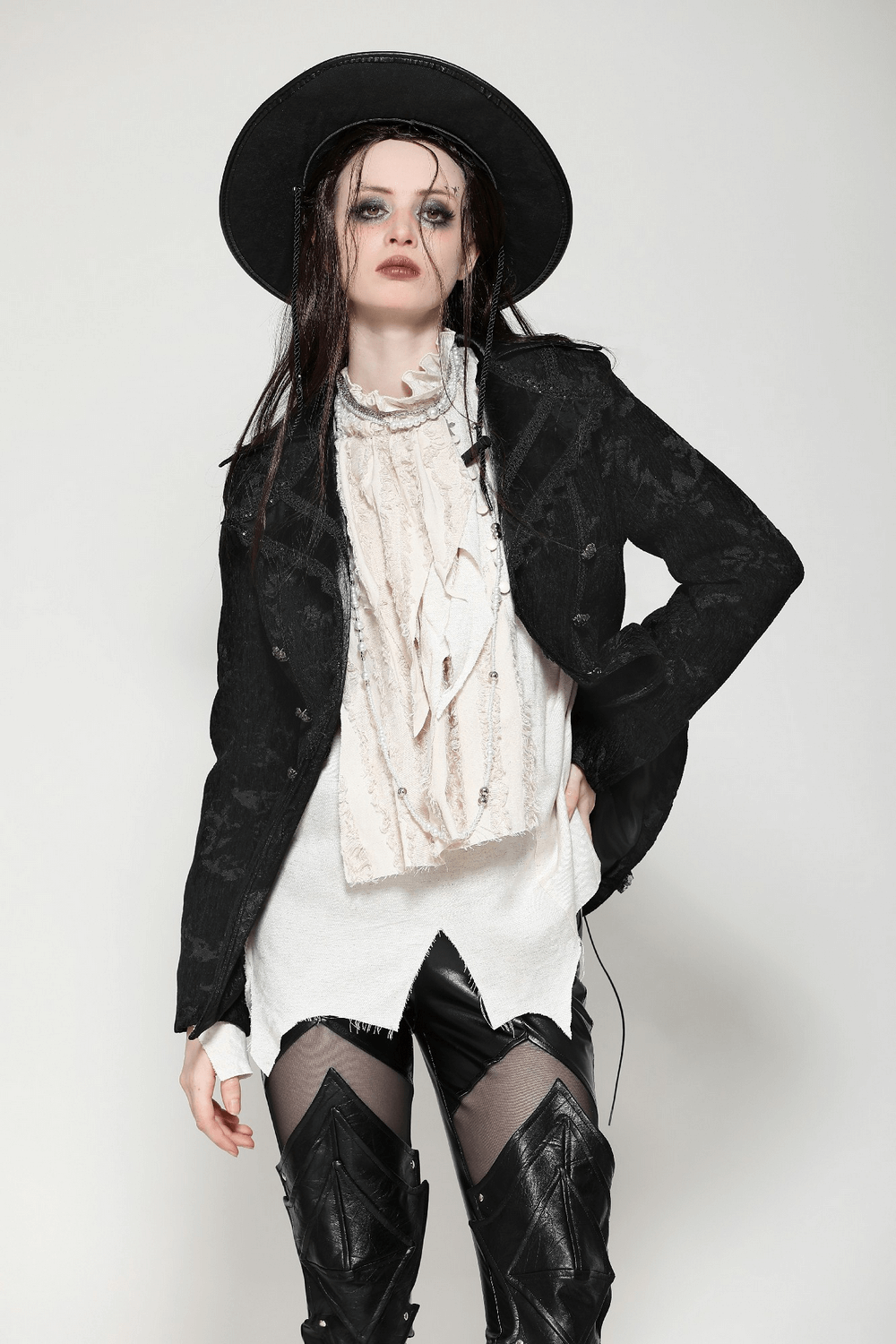 Model showcasing a gothic jacket with lace details, statement buttons, and a dramatic ensemble for a bold look.