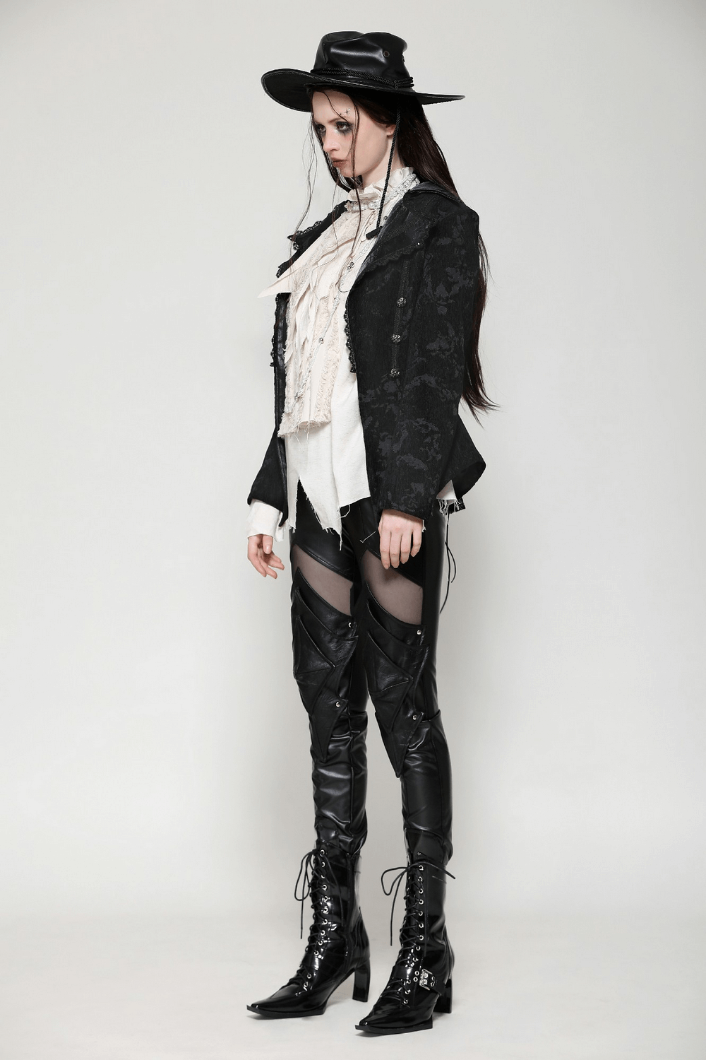 Gothic fashion look featuring a chic lace-trimmed jacket, stylish knee-high boots, and a dramatic hat. Perfect for edgy style!