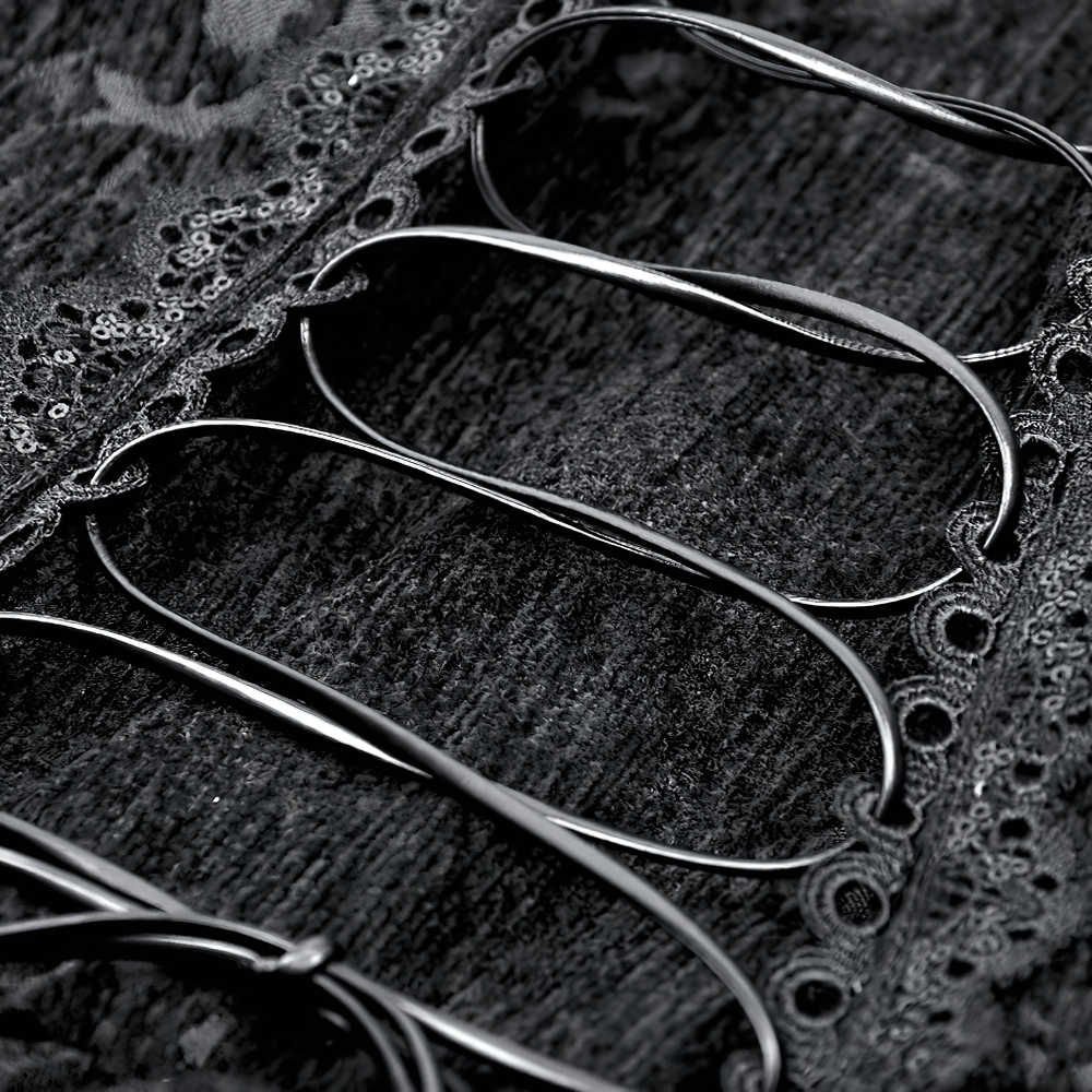 close-up of ornate statement buttons on a gothic velvet jacket with lace trim