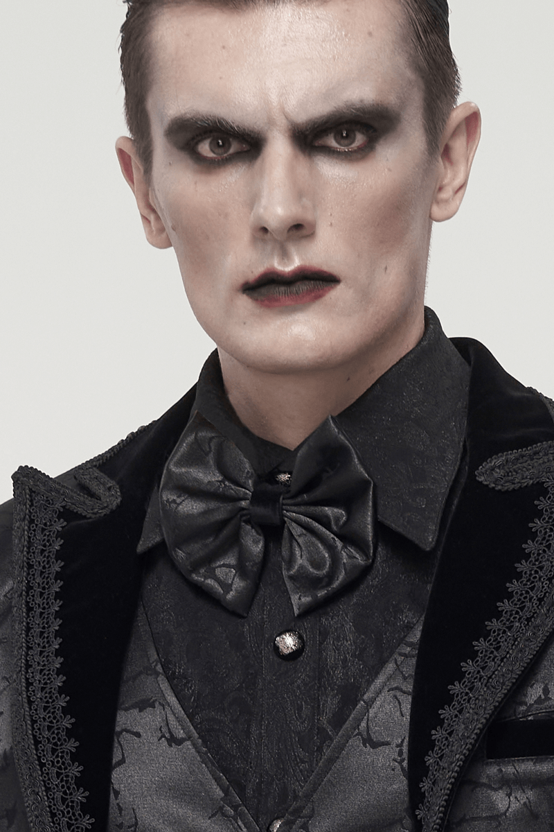 Gothic men's style featuring a black jacquard bowtie, dark attire, and dramatic makeup for a striking look.