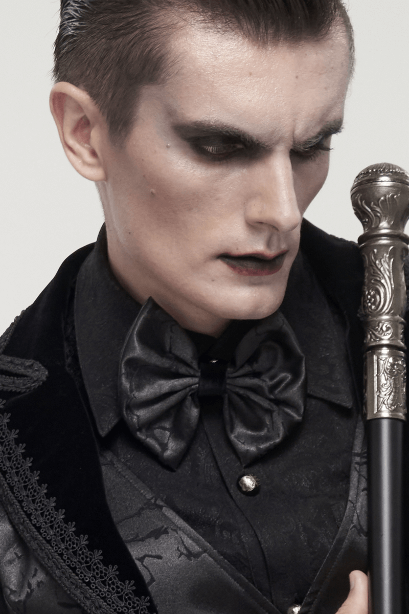 Gothic men’s black bow tie in a stylish outfit, featuring an elegant lace-up design and striking makeup.