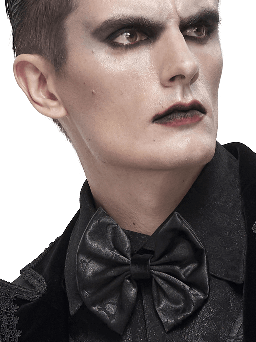 Stylish man wearing a gothic black jacquard bow tie, showcasing an elegant and edgy fashion statement.