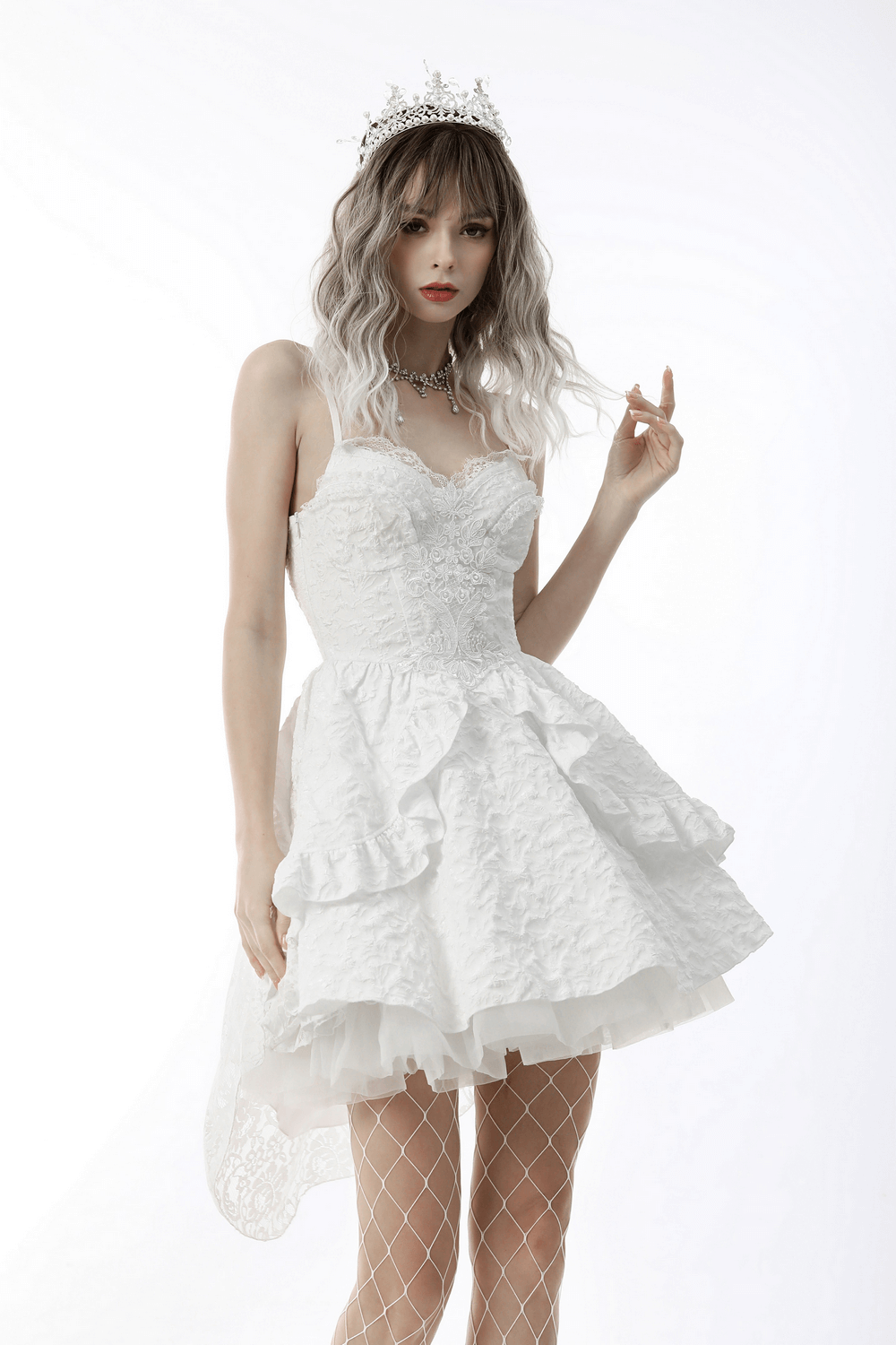 Chic white hi-low wedding dress with ruffles, off-the-shoulder neckline, and crown, embodying gothic elegance.