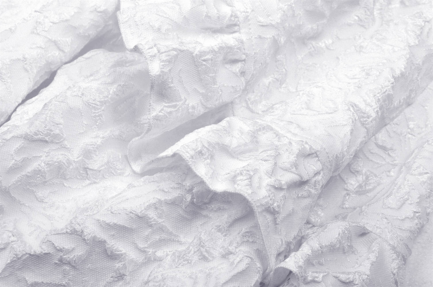 Intricate white jacquard fabric showcasing a textured floral pattern, perfect for gothic wedding dresses.