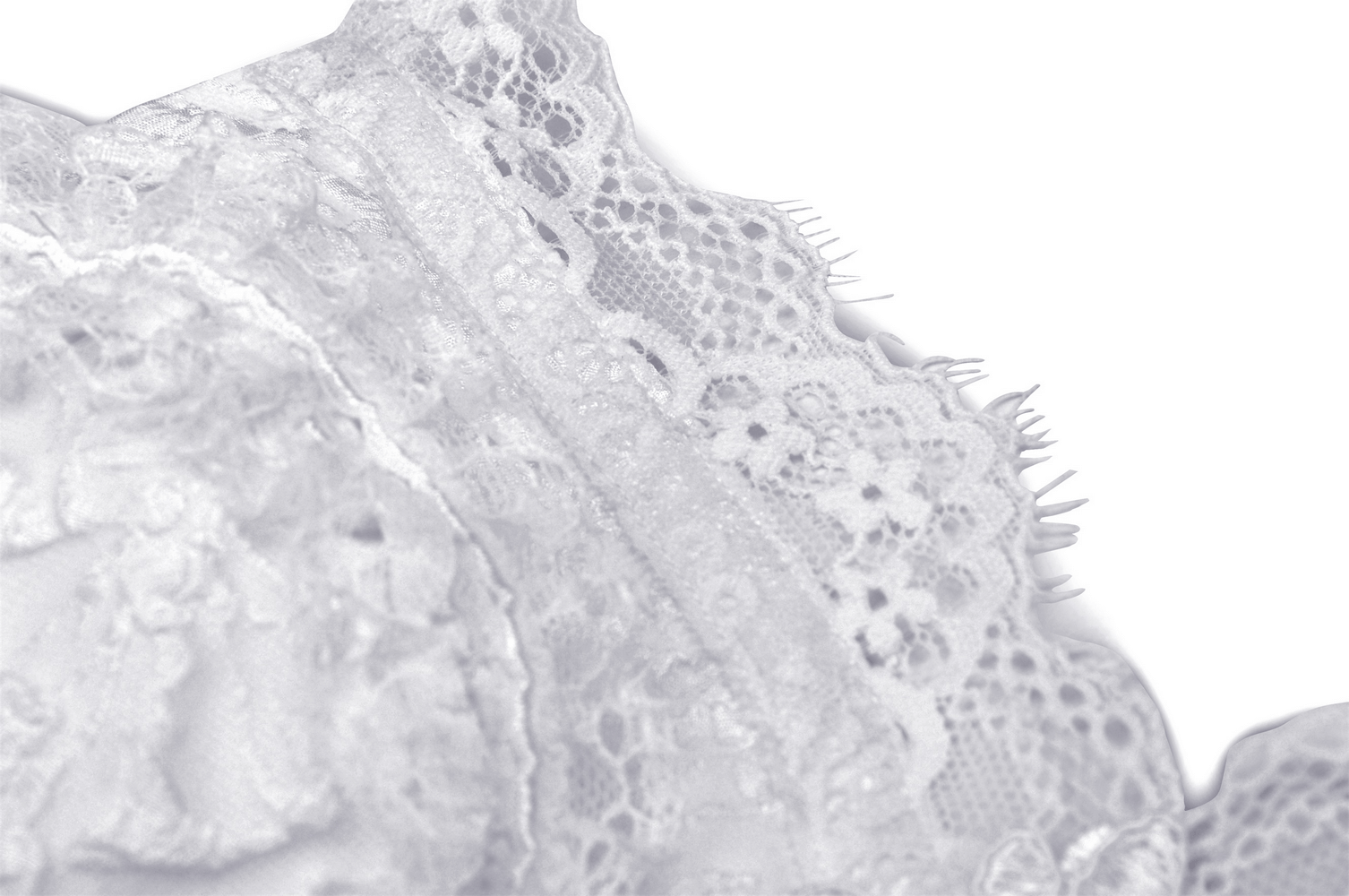 Close-up of delicate white lace fabric showcasing intricate patterns and textures, perfect for wedding attire.