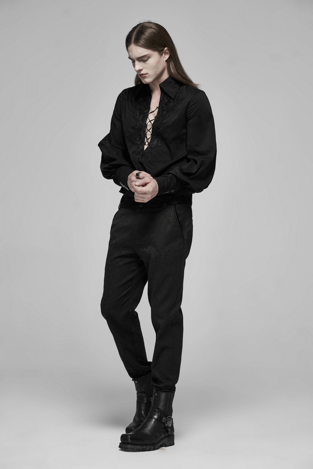 Model wearing Gothic Jacquard Lace Pants and a black lace-up shirt, styled with rugged black boots.