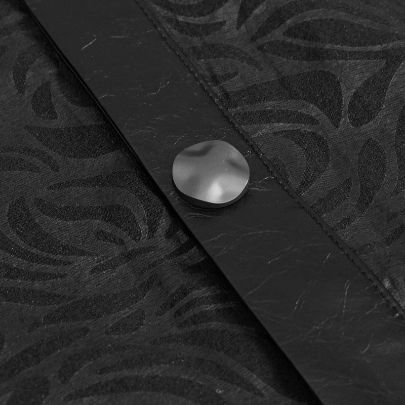 Close-up of gothic black shirt fabric with PU leather insert and decorative button, showcasing stylish detailing.