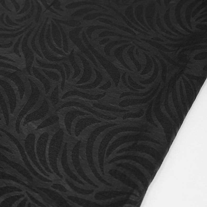 Close-up of intricate black jacquard fabric with a swirling pattern, perfect for gothic fashion.