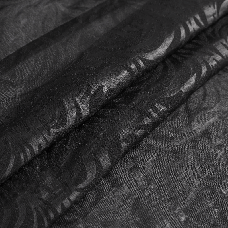 Close-up of gothic jacquard fabric in black with intricate designs, perfect for a stylish men's shirt.