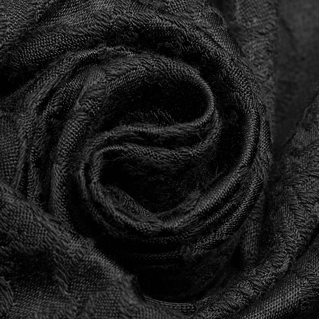 Close-up of luxurious black jacquard fabric in a rose shape, perfect for gothic fashion.