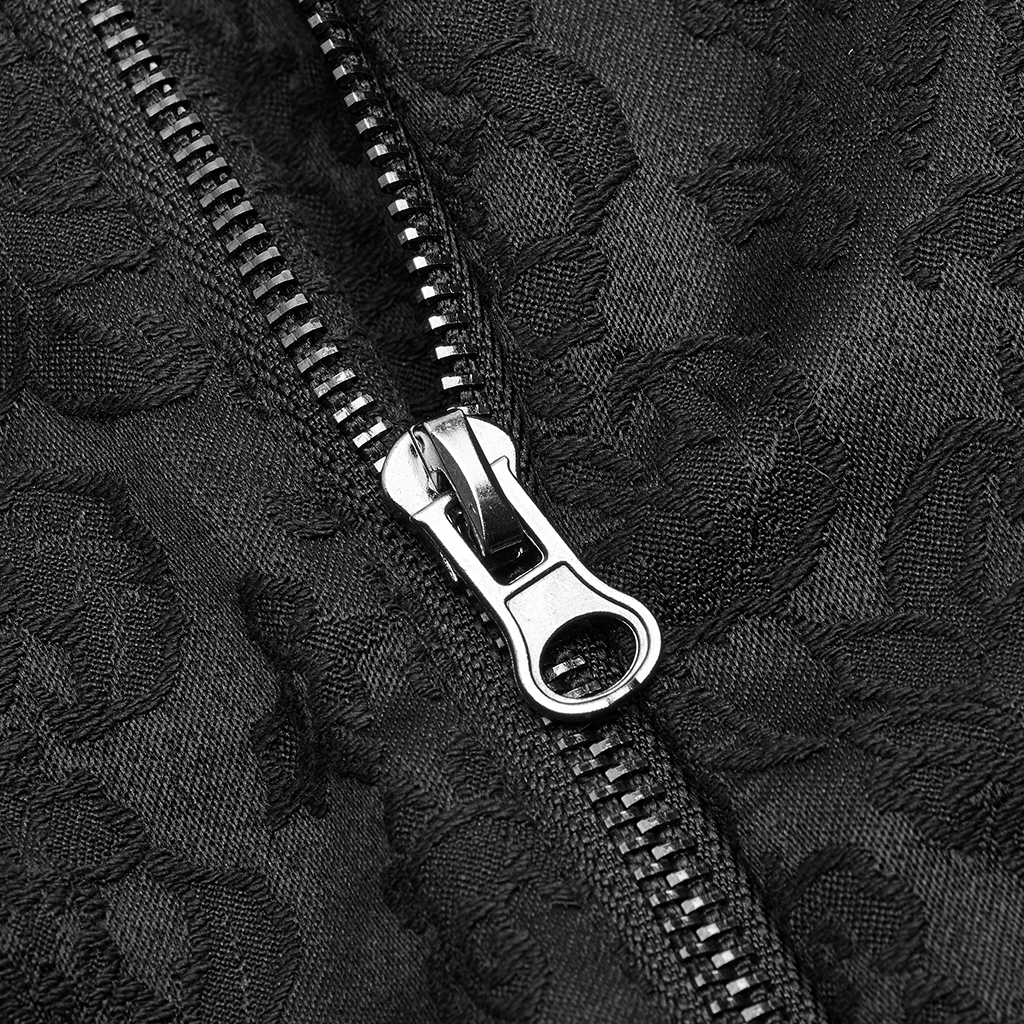 Close-up of a sleek black zipper on textured matte jacquard fabric, showcasing gothic fashion details.