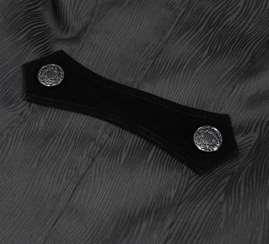 Close-up of black jacquard fabric featuring ornate silver buttons on a gothic coat.