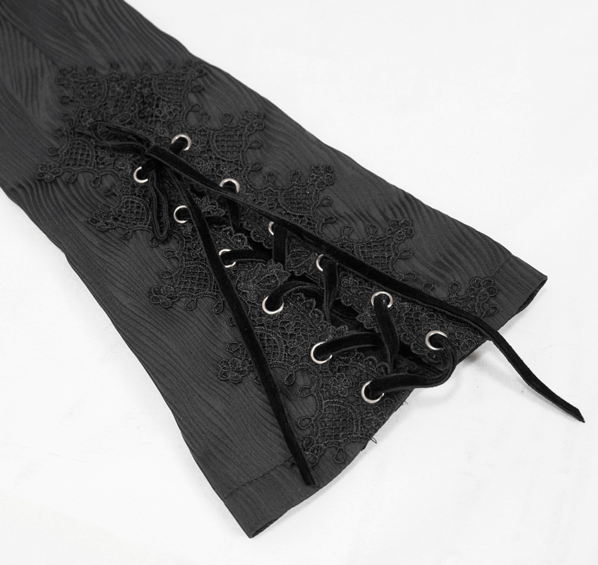Close-up of gothic black coat sleeve featuring lace inserts and decorative lacing details.