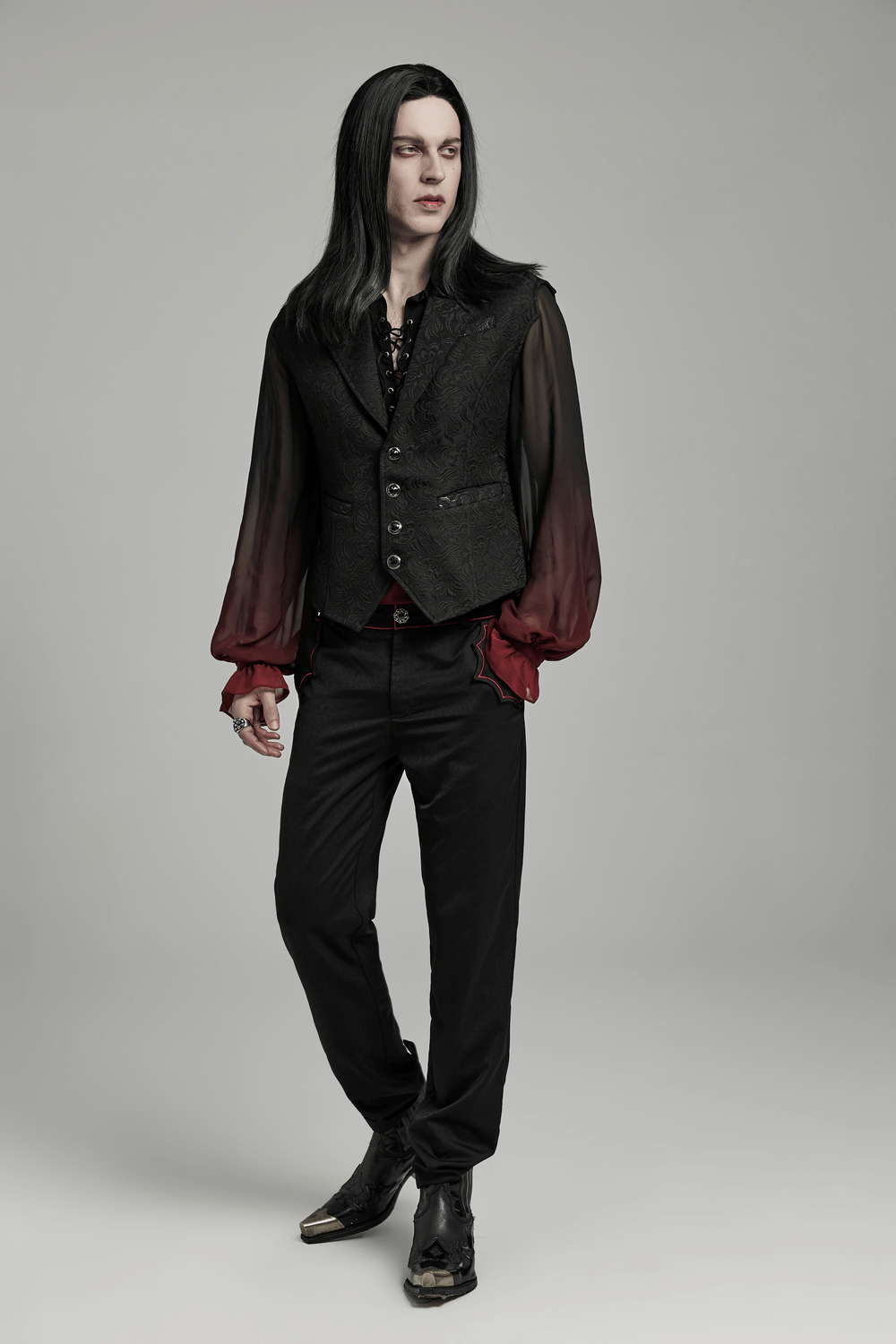 Gothic jacquard waistcoat with gemstone buttons and bat wing design, worn with stylish black and red attire.