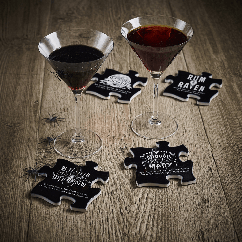 Gothic jigsaw coasters with Halloween cocktail recipes alongside stylish drinks on a rustic wooden table.