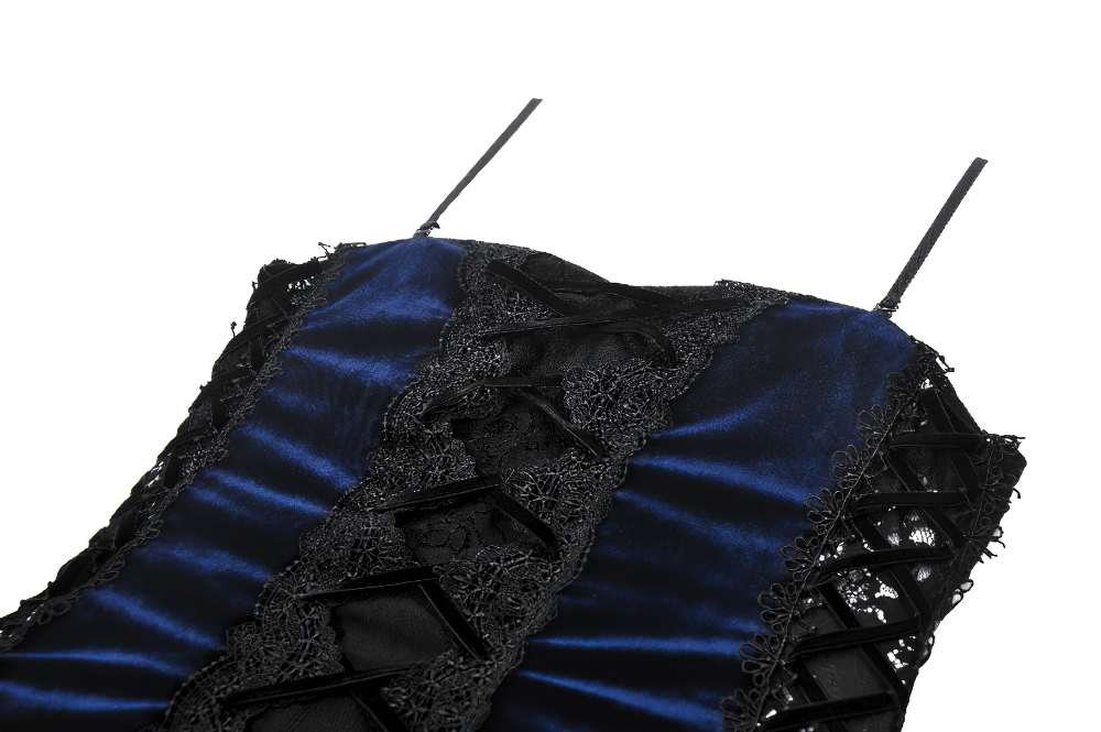 Close-up of elegant gothic corset dress featuring velvet, lace, and chain details with a ruffled skirt.
