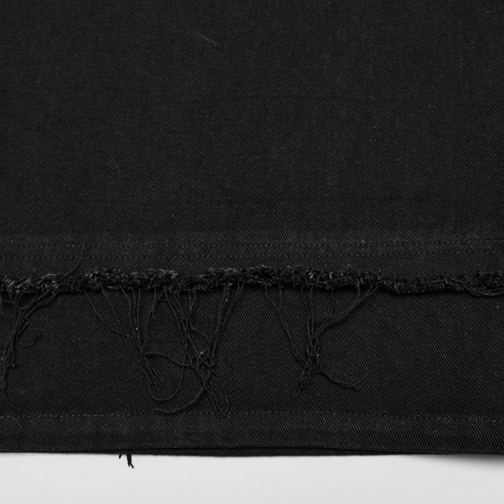 Close-up of the raw hem detail on gothic lace and rivet embellished denim pants, showcasing punk style and edgy texture.