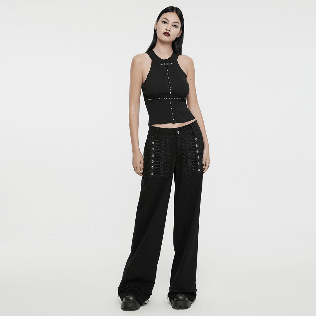 Model wearing gothic lace and rivet embellished denim pants with a stylish black crop top.