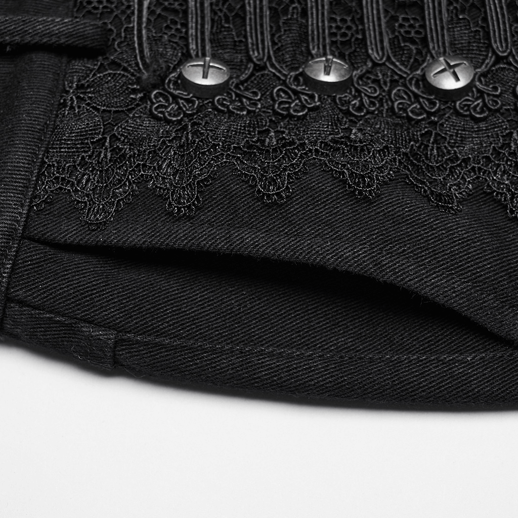 Close-up of gothic lace and rivet detail on black denim pants, showcasing punk style and intricate design.