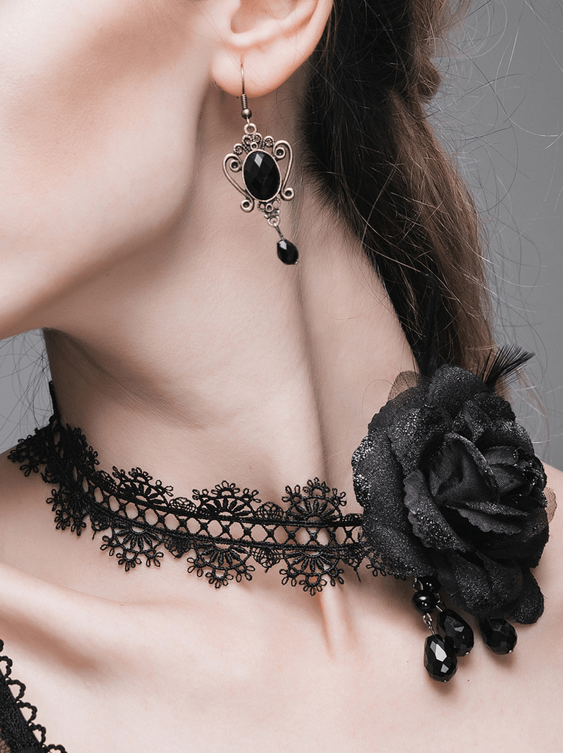 Elegant black lace choker with a rose accent and matching vintage earrings, perfect for gothic fashion lovers.