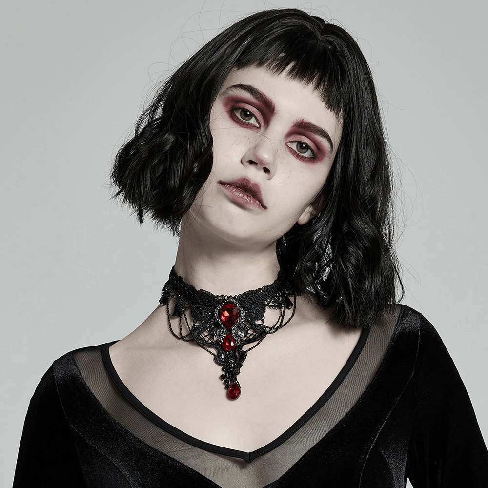 Gothic lace and ruby pendant necklace worn by model, showcasing a bold gothic style with dramatic makeup.