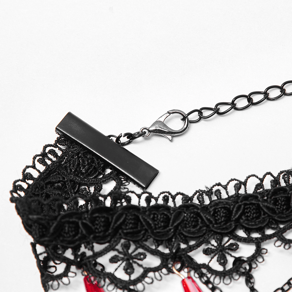Close-up of the adjustable chain and clasp of a gothic lace necklace with ruby accents.