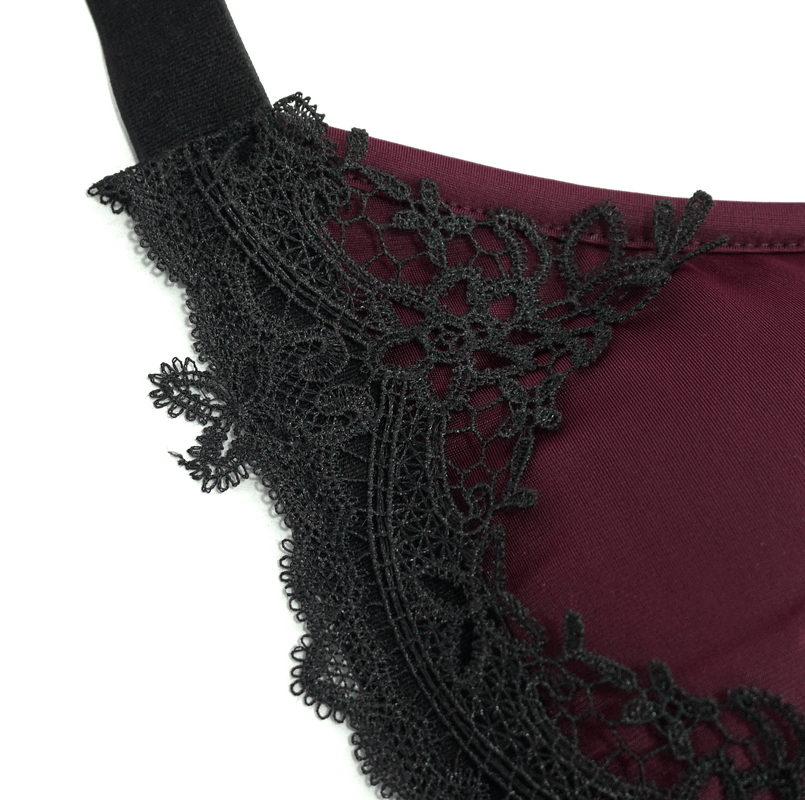Close-up of elegant burgundy swimsuit with gothic black lace detailing and elastic straps, perfect for a stylish beach look.