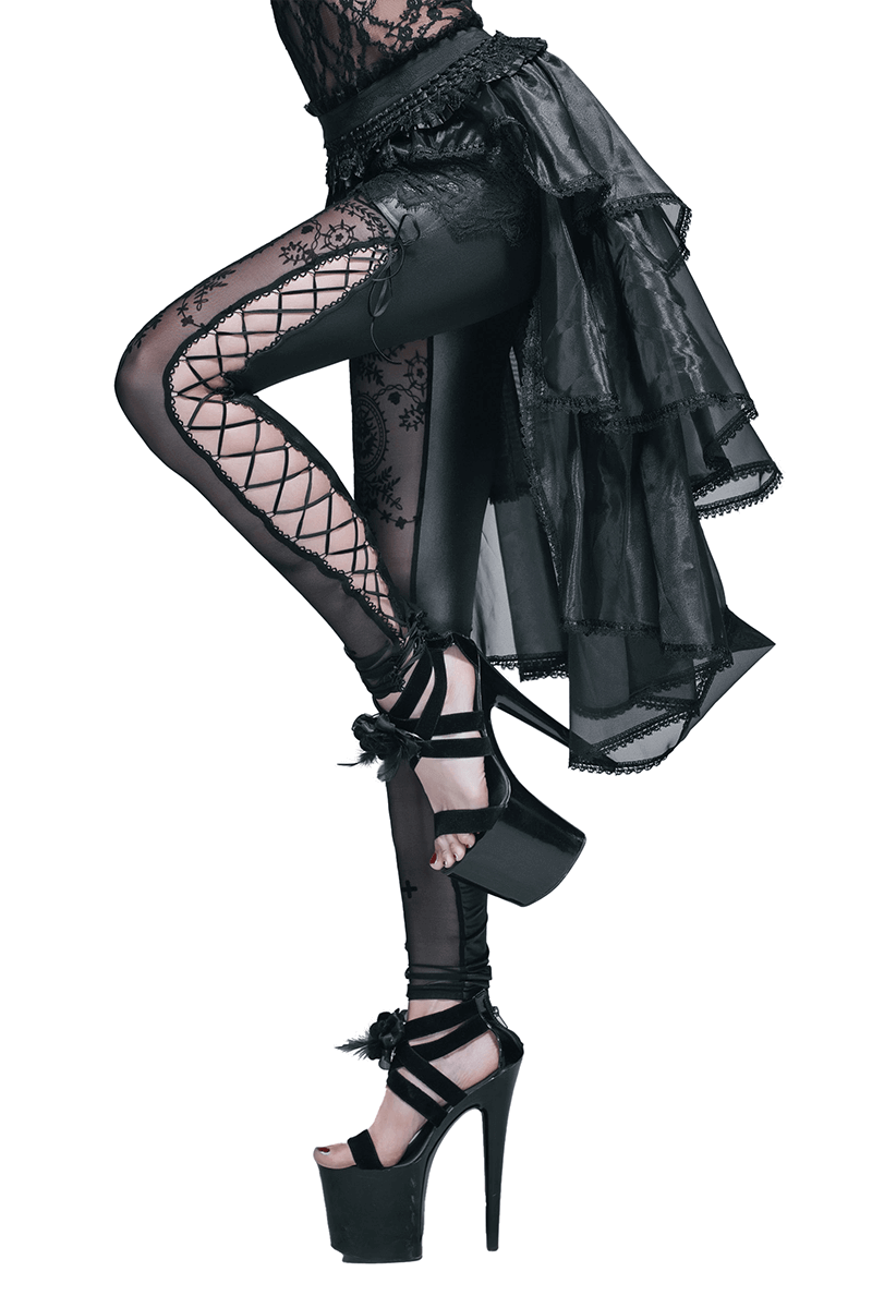 Woman in gothic-style asymmetrical black lace skirt with fishnet leggings and high heels, showcasing punk fashion.