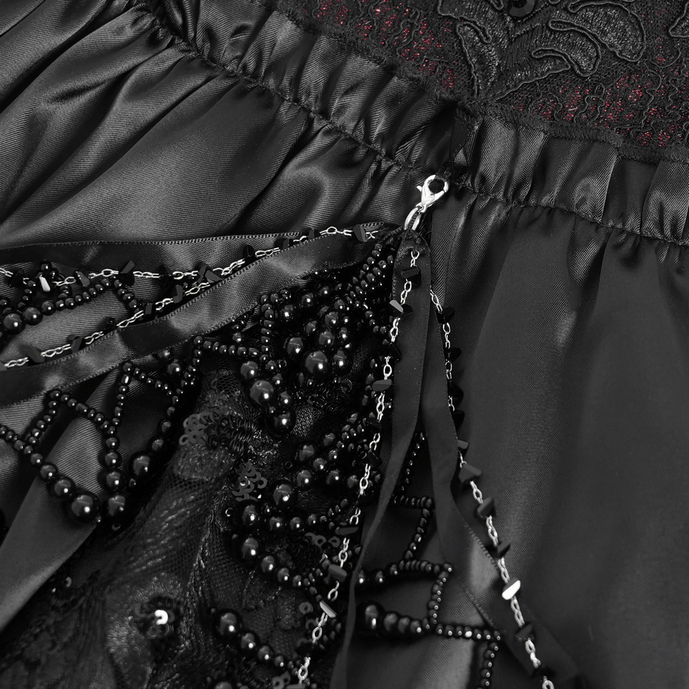 Close-up of Gothic lace-back maxi dress featuring intricate chain detail and elegant lacing on black fabric.