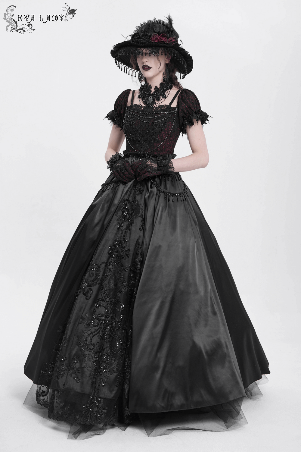 Elegant gothic lace-back maxi dress with chain detail, featuring intricate lacing and dramatic accessories.
