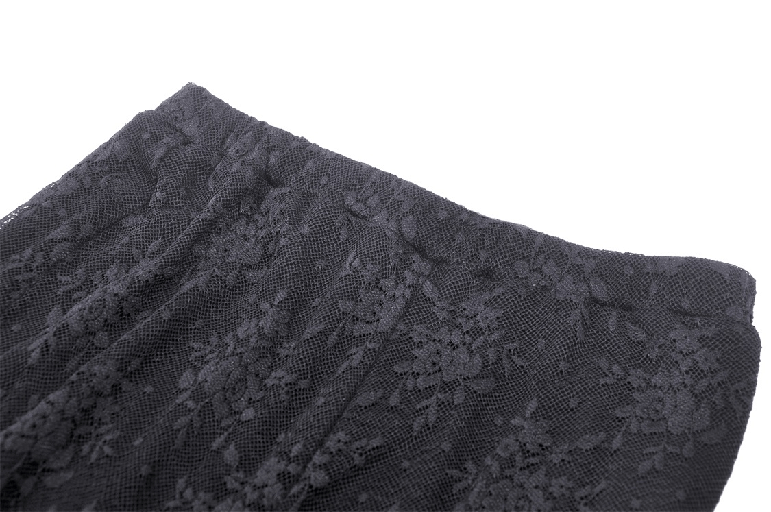 Close-up of elegant Gothic lace details on stylish bell-bottom pants for a trendy gothic look.