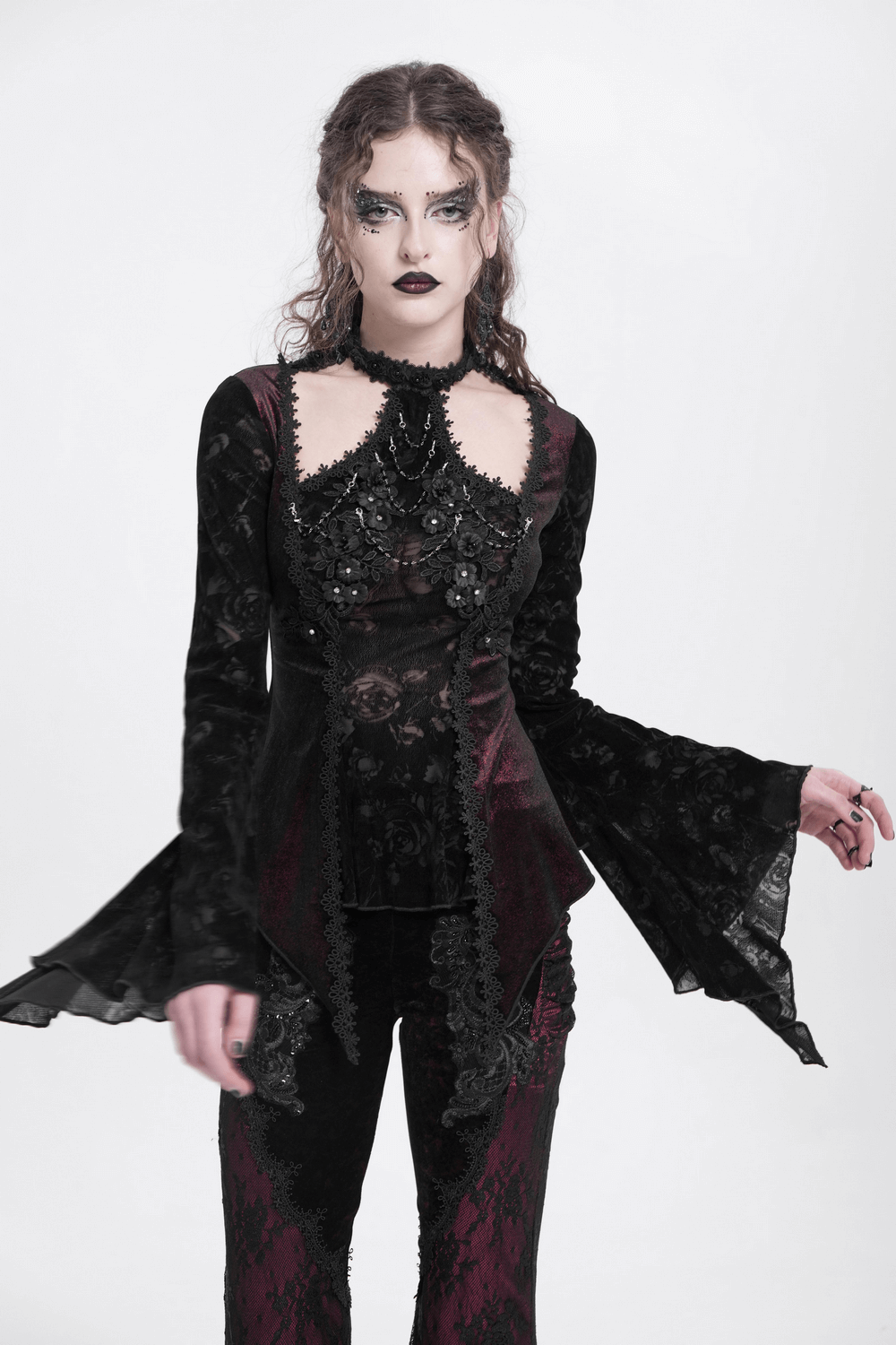 Gothic lace top with bell sleeves, rose embellishments, and high-neck collar for a dark, romantic style.