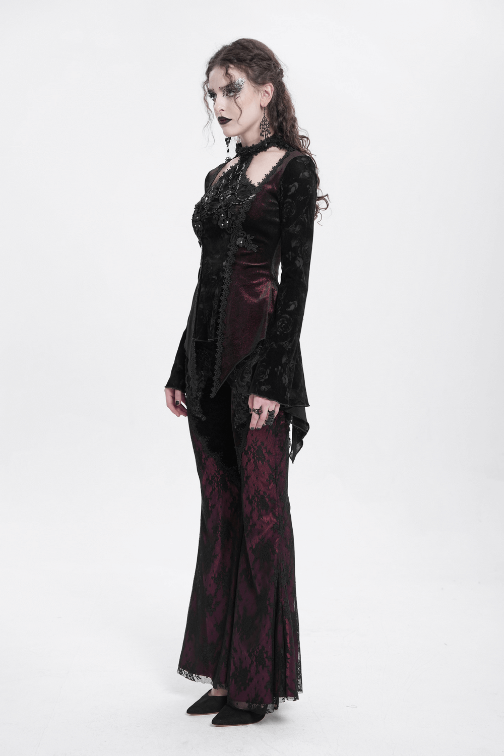 Gothic lace top with flared sleeves, paired with elegant dark red pants, perfect for alternative fashion lovers.