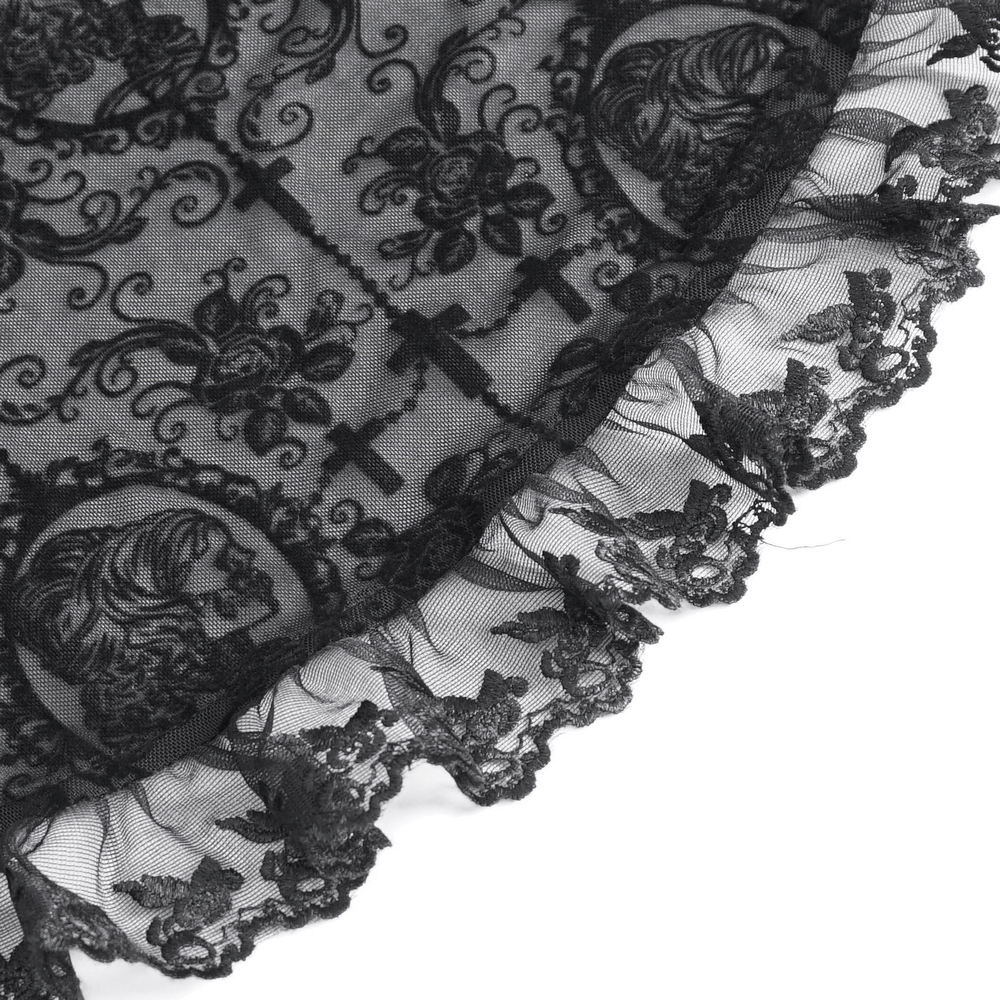 Close-up of black lace fabric with intricate floral and cross patterns and a ruffled edge, perfect for gothic fashion.