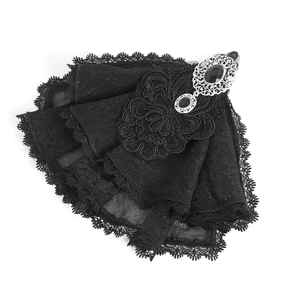 Victorian black lace handkerchief with intricate embroidery and vintage brooch, perfect for gothic elegance.