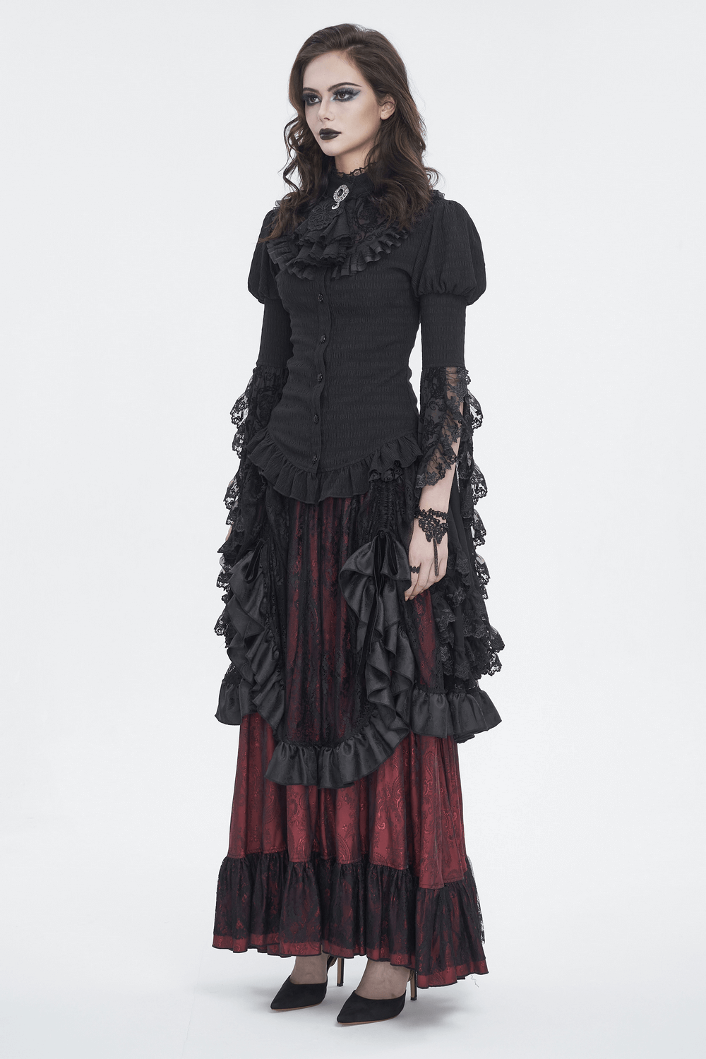 Model wearing a gothic lace blouse with ruffled neck and flare sleeves, paired with a dramatic skirt for Victorian elegance.