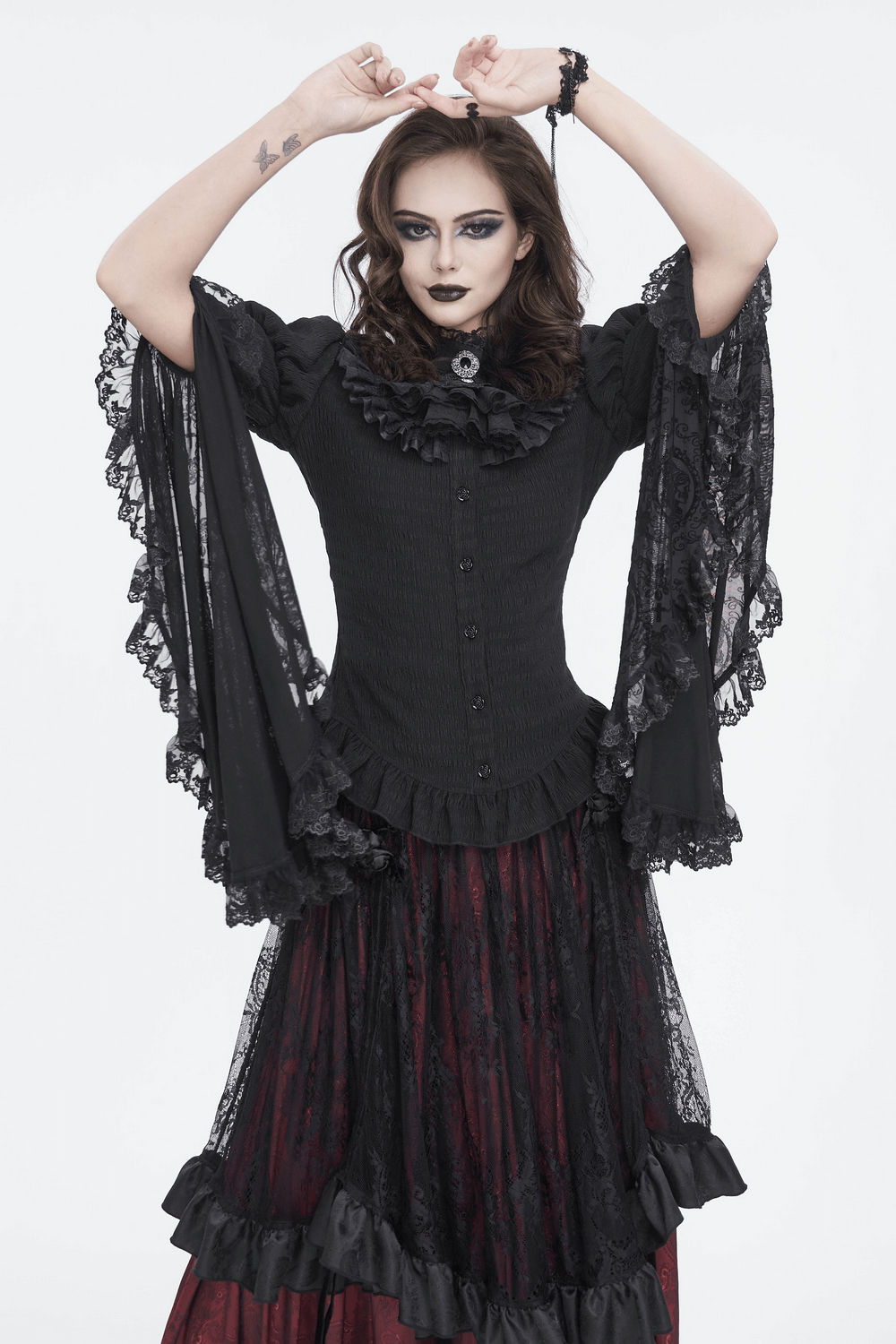 Gothic lace blouse with ruffled neck and flare sleeves, styled with a dramatic black skirt.
