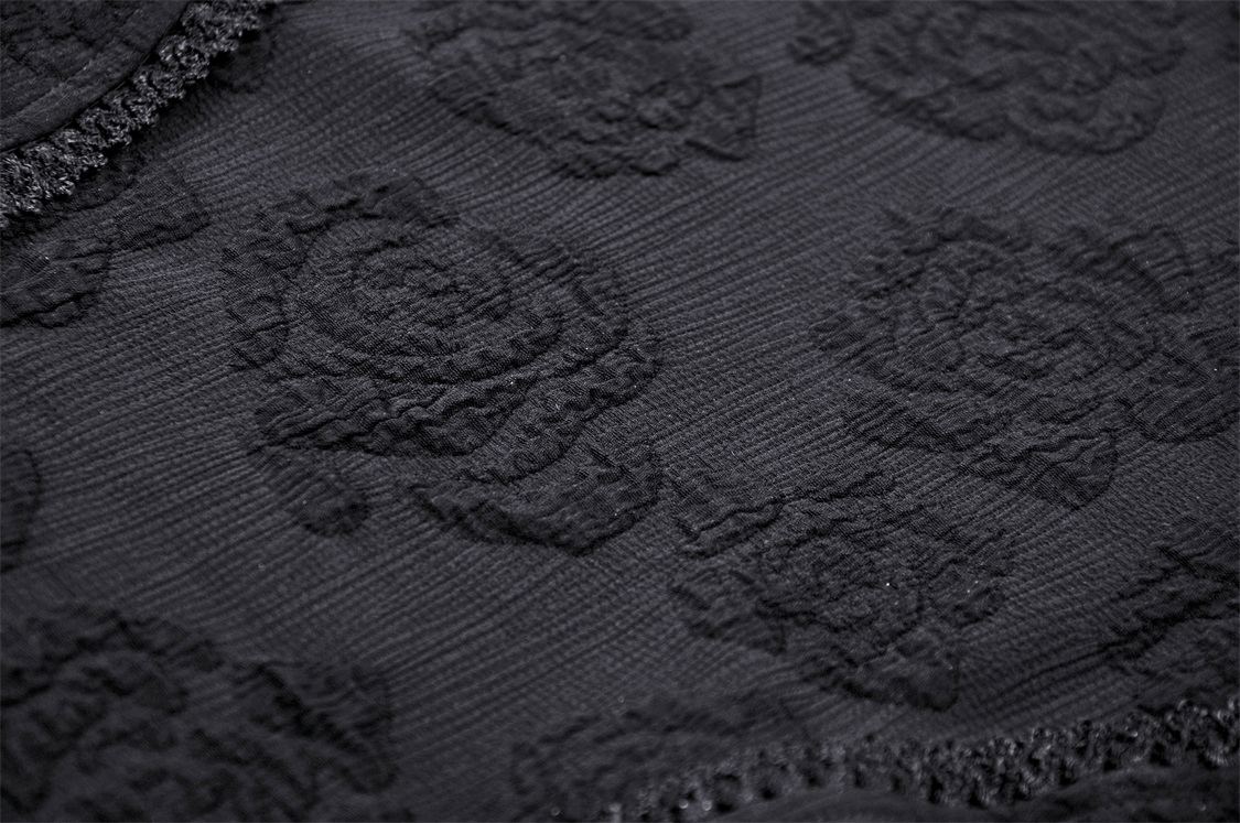 Close-up of intricate black jacquard fabric featuring rose patterns, perfect for gothic fashion.