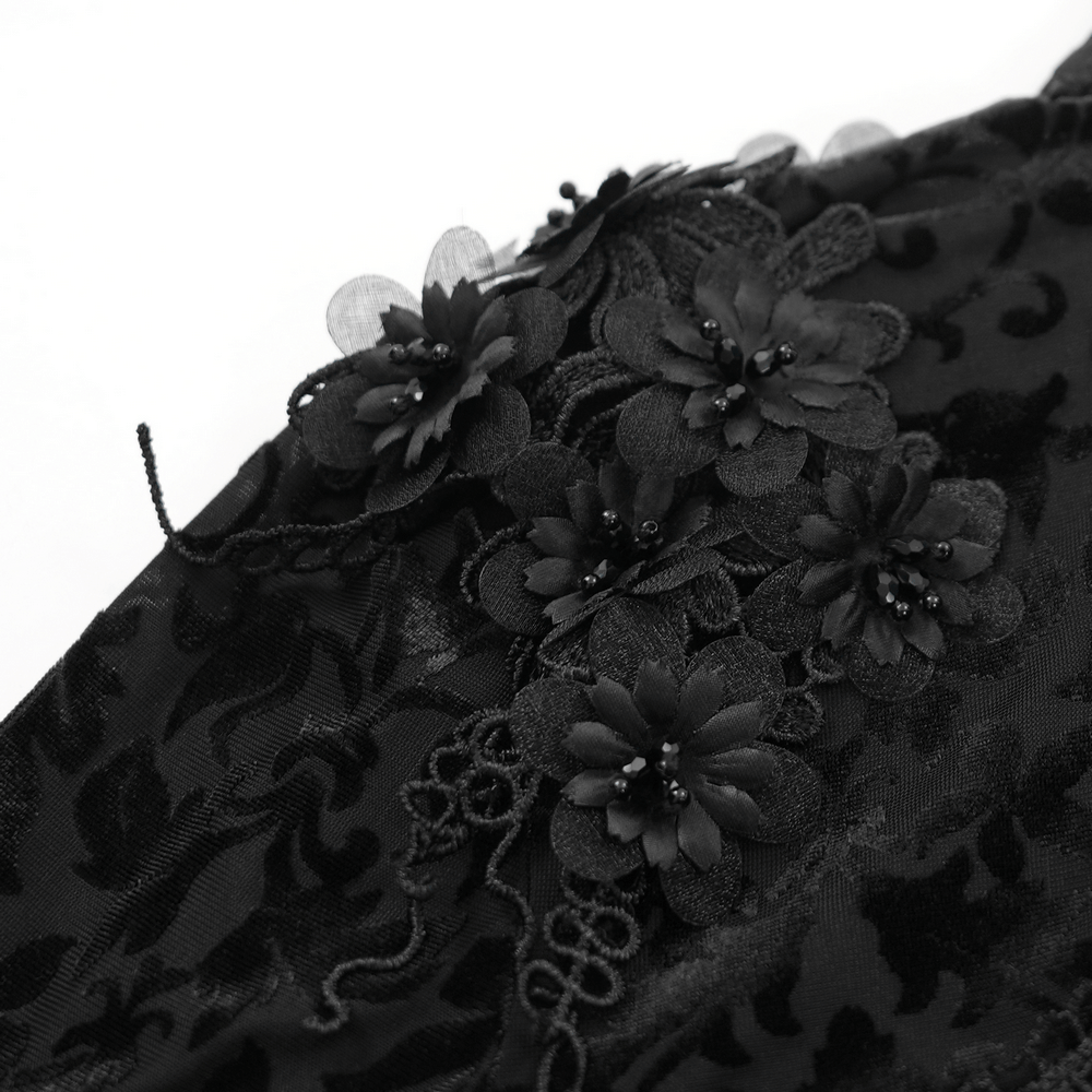 Close-up of intricate black floral lace embellishments on a gothic lace bolero, adding elegance to gothic fashion.